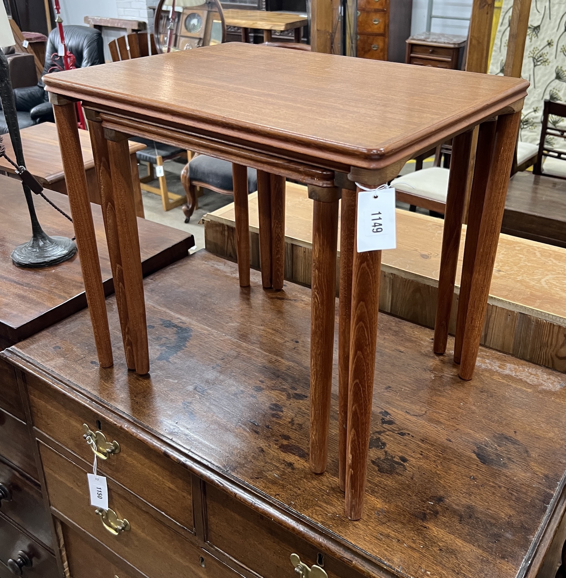 A nest of three rectangular teak mid century Danish style tea tables, width 55cm, depth 40cm, height 49cm